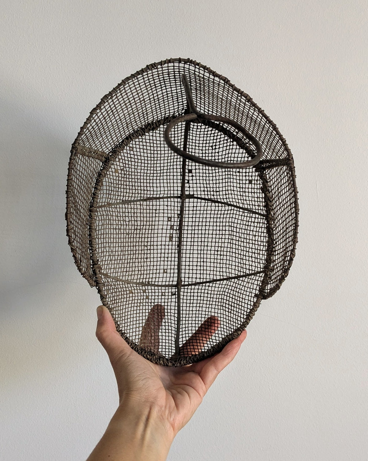 Interior view of 19th-century fencing mask showing original wire frame construction