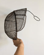 Side of 19th-century fencing mask with sculptural wire mesh construction