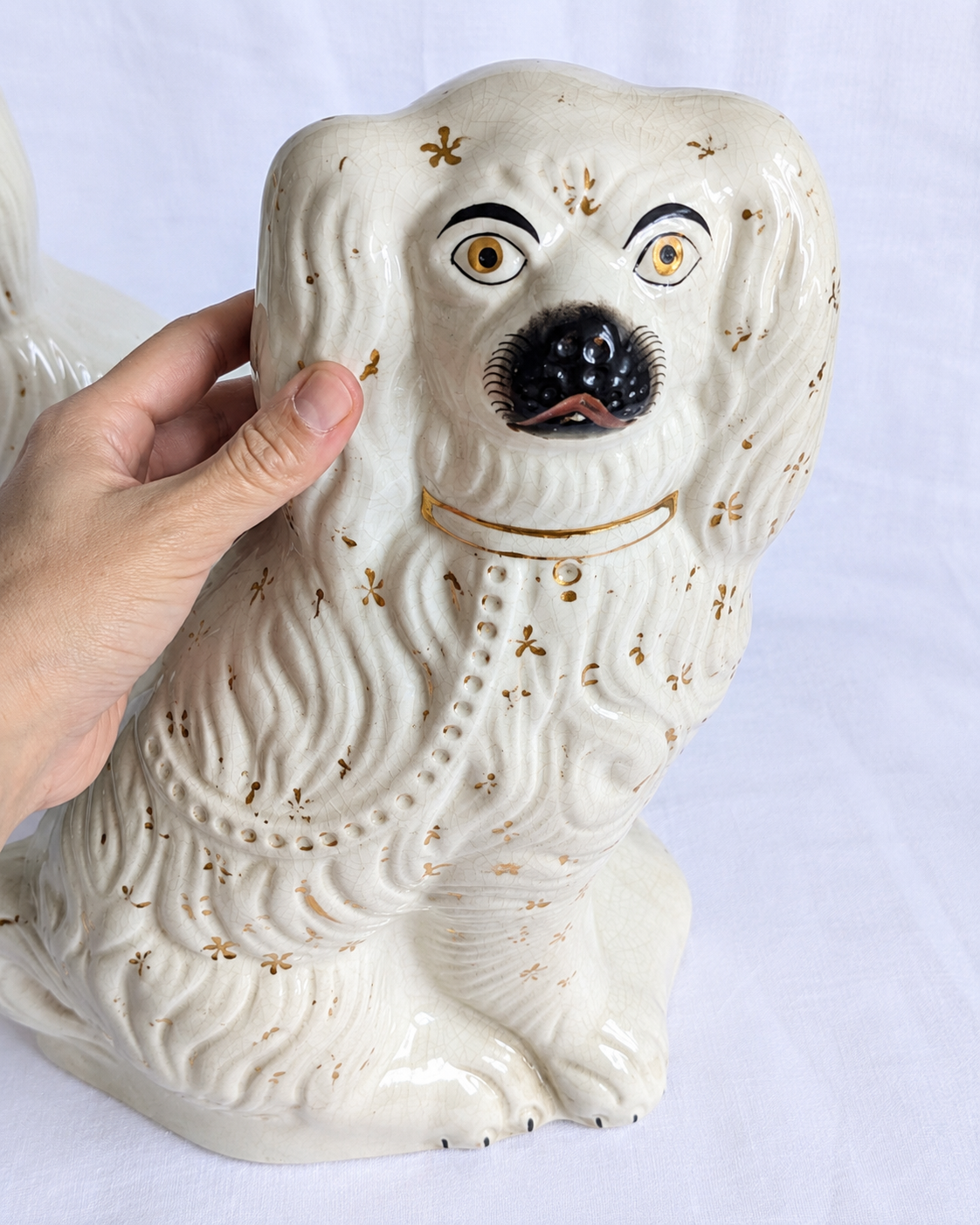 Antique Staffordshire spaniel dogs with cream glaze and gold stars