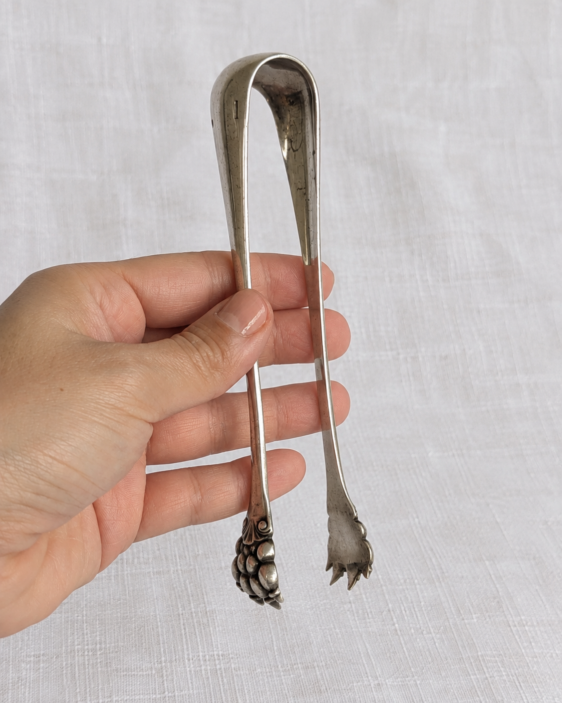 Decorative handle detail on late 19th-century Christofle sugar tongs