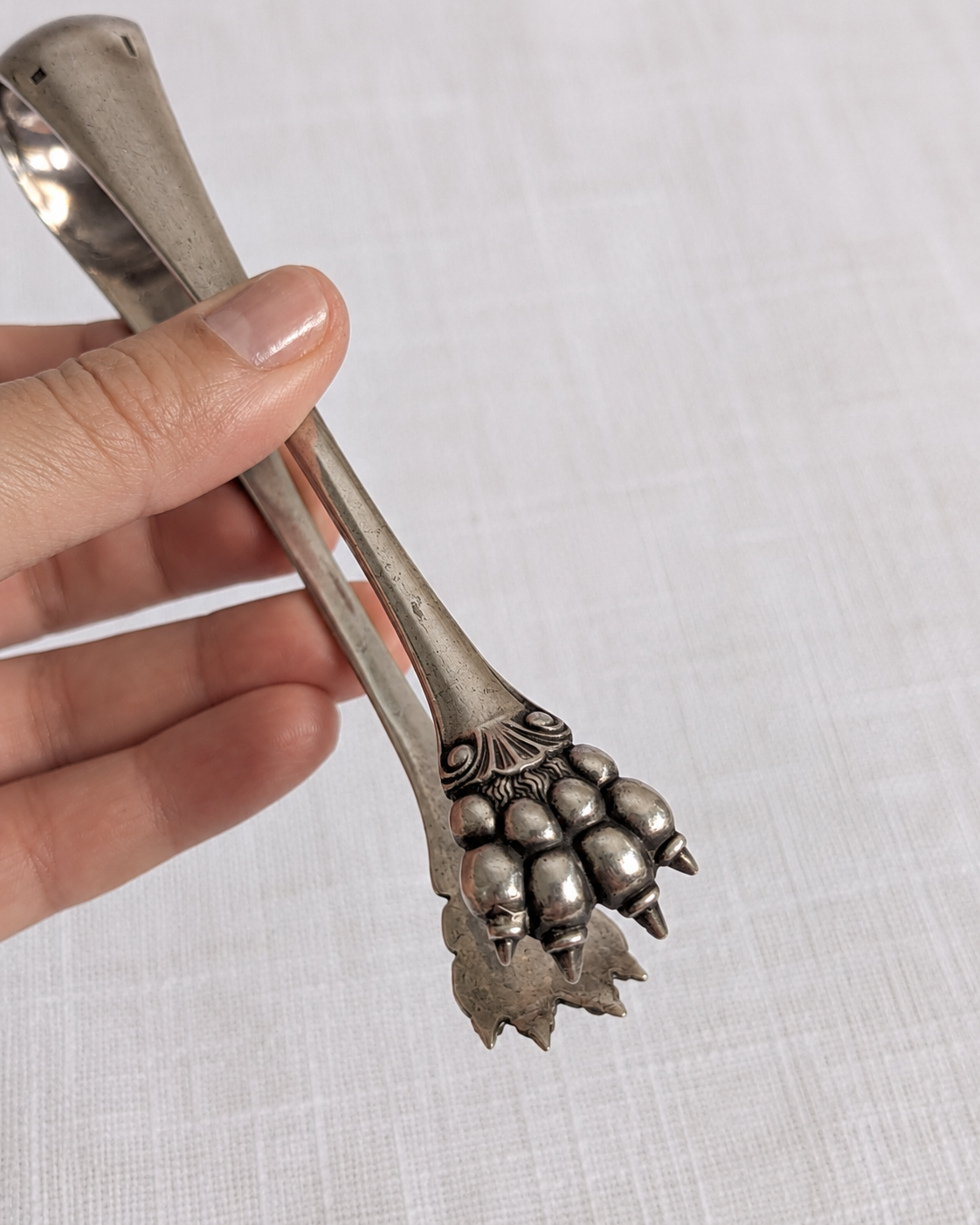 Condition detail of late 19th-century Christofle silver-plated sugar tongs