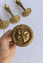 Floral rosette on antique French gilt bronze curtain tieback
