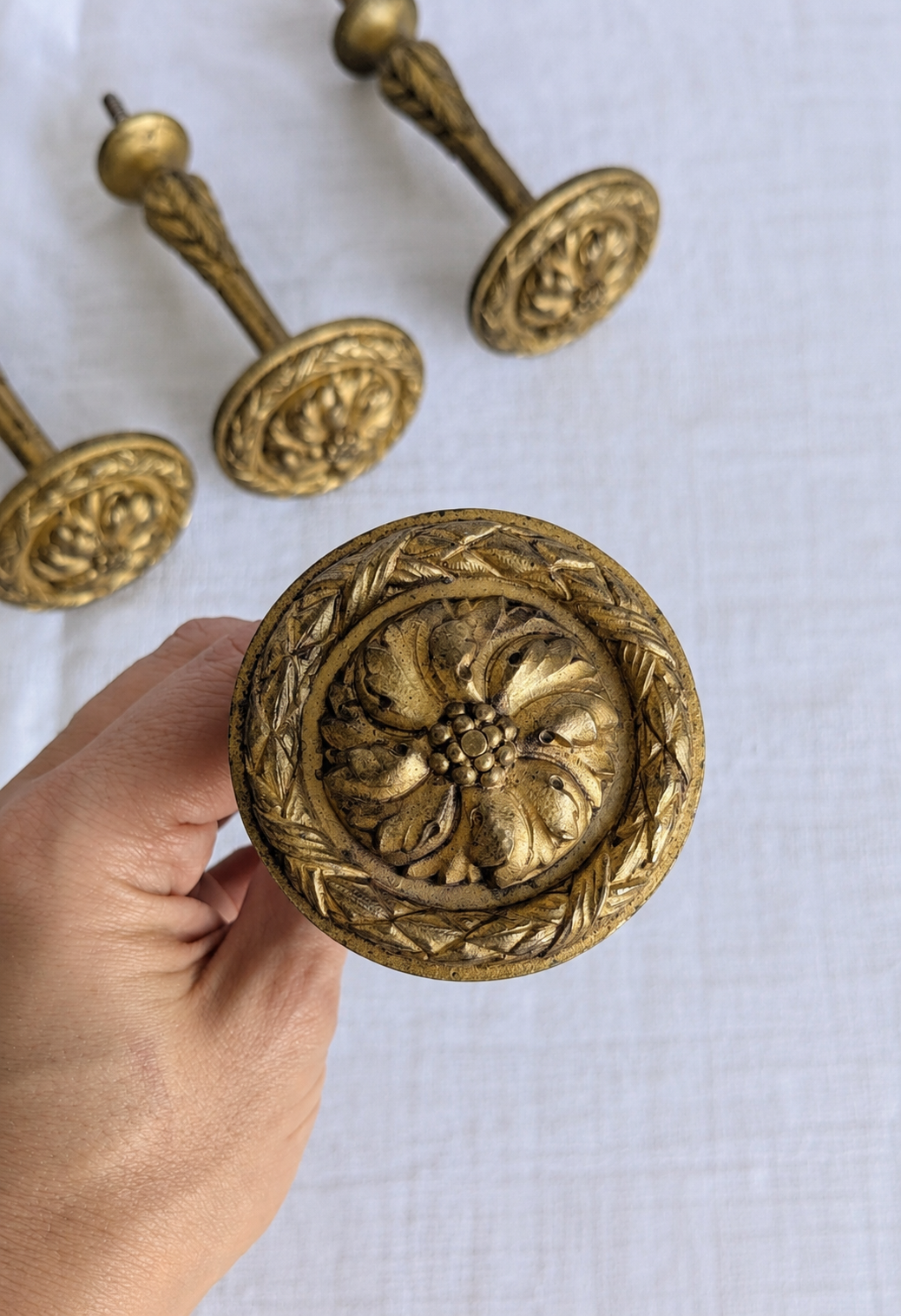 Floral rosette on antique French gilt bronze curtain tieback