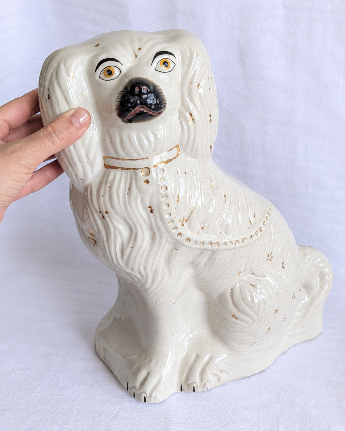 Close-up of Victorian Staffordshire spaniel hand-painted face